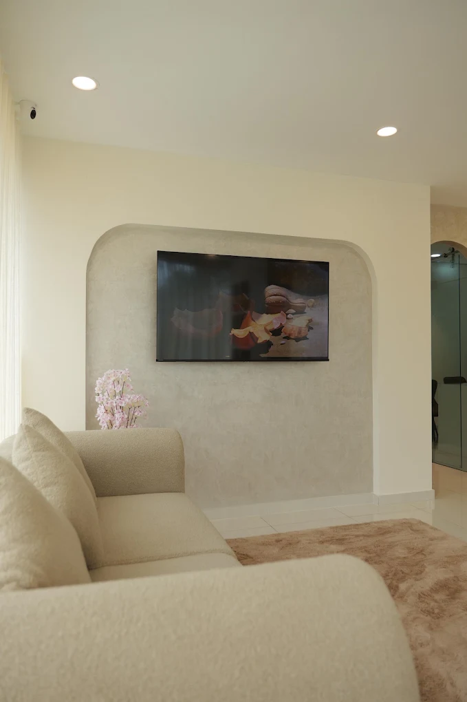 Patient media lounge with arched wall niche and cozy seating